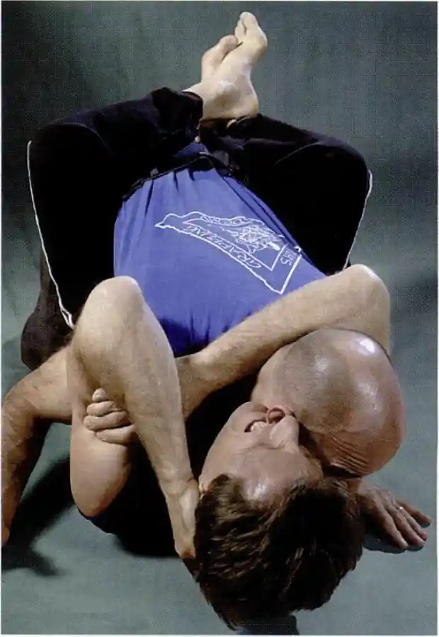 Uninterrupted biting: Key-locking his arms around his opponent's neck, Paul Vunak is able to inflict pain with his teeth while preventing the other man from escaping or retaliating.